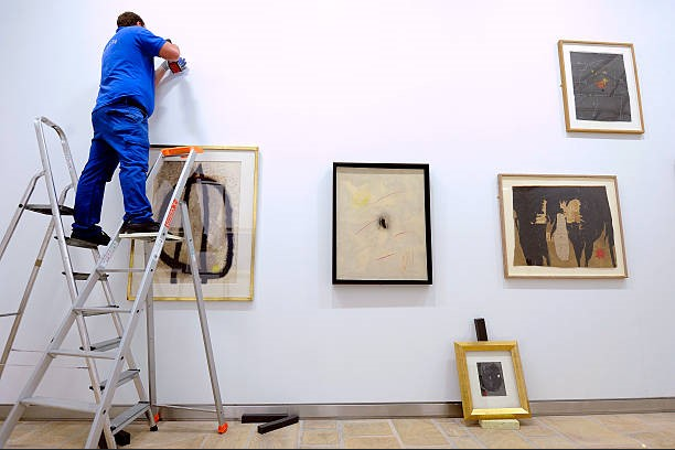 How to Hang Wood-Frame Signs on Drywall Without Crooked Frames or Wall Damage