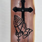 Handcrafted cedar cross with praying hands and rosary. Rustic Christian wall art—perfect for home décor, prayer room, or meaningful gift.
